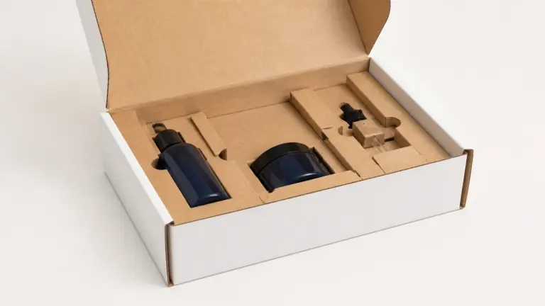 Mailer box insert design showing finger access, side restraint and clearance around three products.